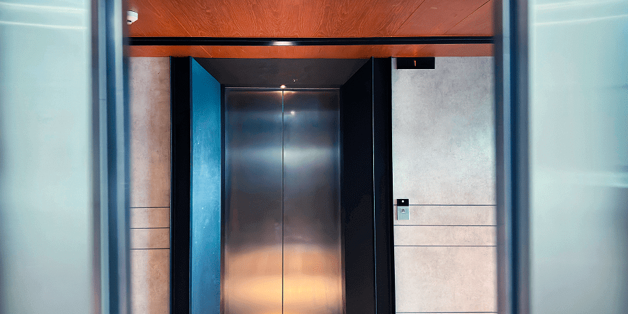 Elevator doors opening in modern building.